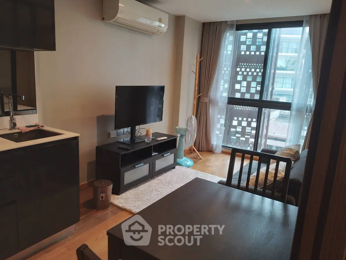 Modern living room with sleek furniture and large window for natural light