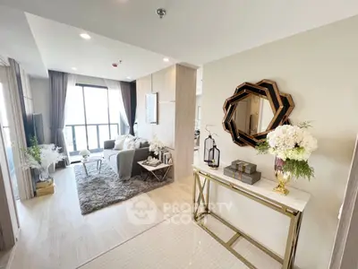 Elegant living room with modern furnishings, large windows offering ample natural light, and a cozy seating area perfect for relaxation.