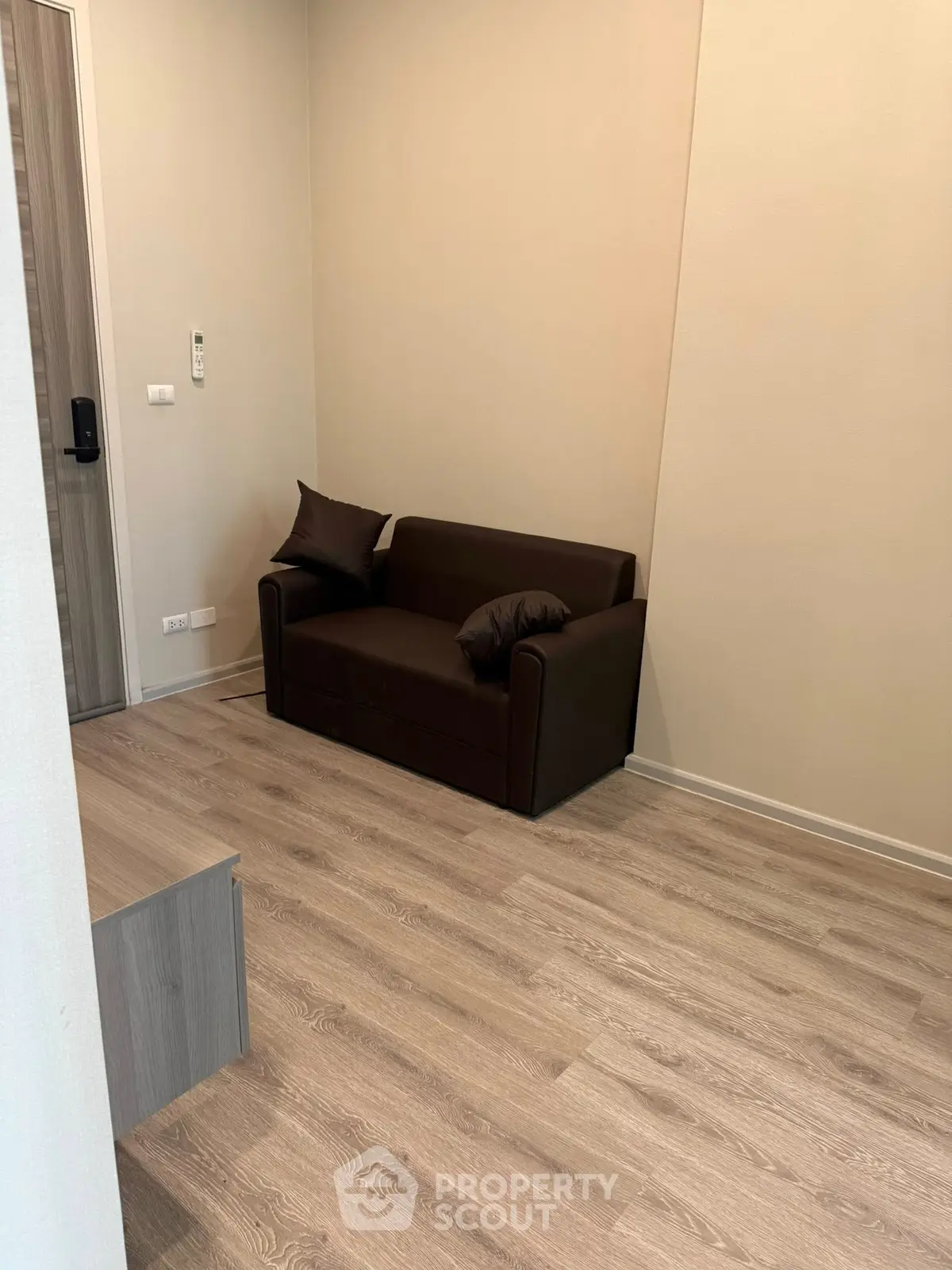 Cozy small living room with modern sofa and wooden flooring