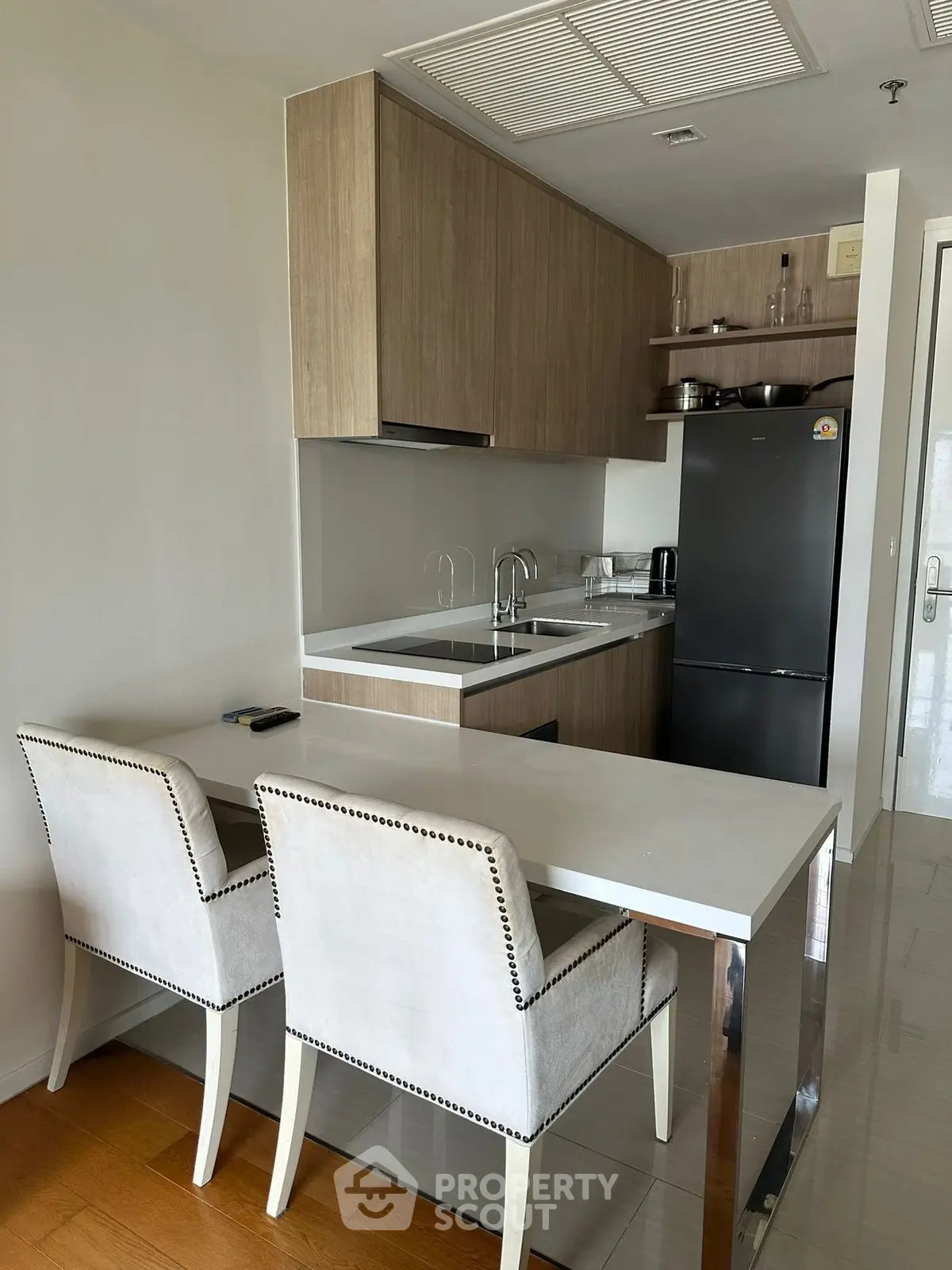Modern kitchen with sleek cabinetry and breakfast bar seating