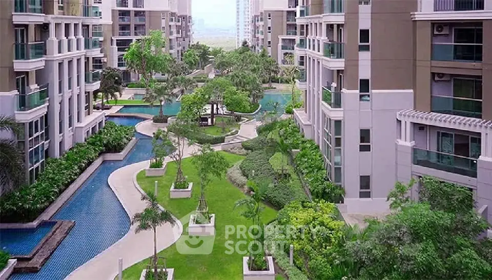 Luxurious condominium complex with lush gardens and swimming pool view