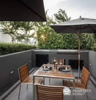 Luxurious outdoor dining area with modern furniture and lush greenery, perfect for entertaining.