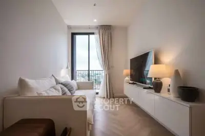 Modern living room with sleek design, large window, and stylish furniture in a high-rise apartment.