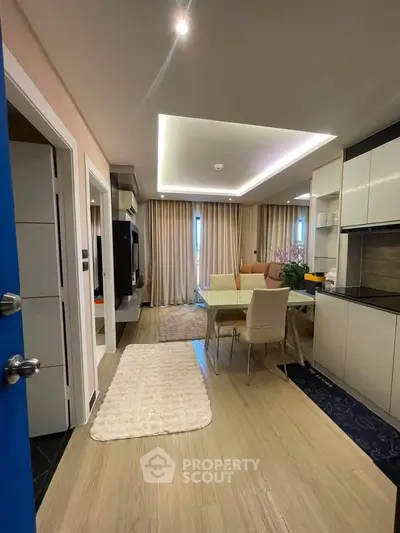 Modern open-plan living and dining area with stylish decor and ample natural light.