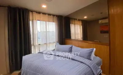 Cozy bedroom with large window and modern decor