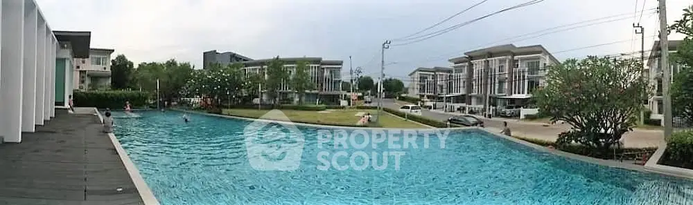 Luxurious residential complex with a stunning outdoor pool and modern architecture.