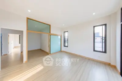 Spacious modern living room with wooden flooring and large windows