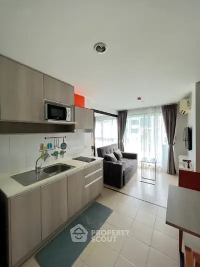 Modern open-layout kitchen and living room with natural light
