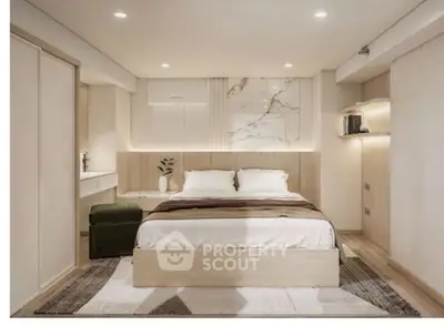 Modern bedroom with stylish decor and ambient lighting, featuring a cozy bed and elegant furnishings.