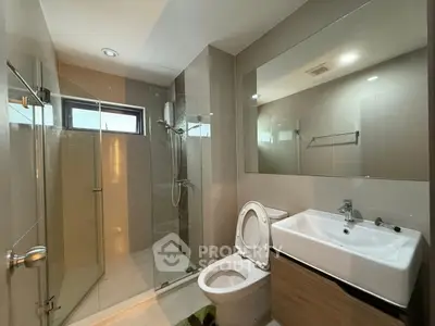 Modern bathroom with glass shower and sleek fixtures