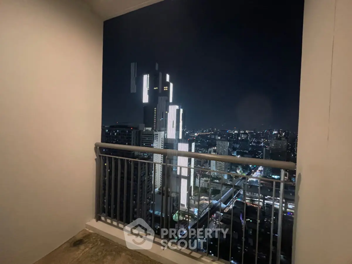 Stunning city view from a high-rise balcony at night, perfect for urban living.