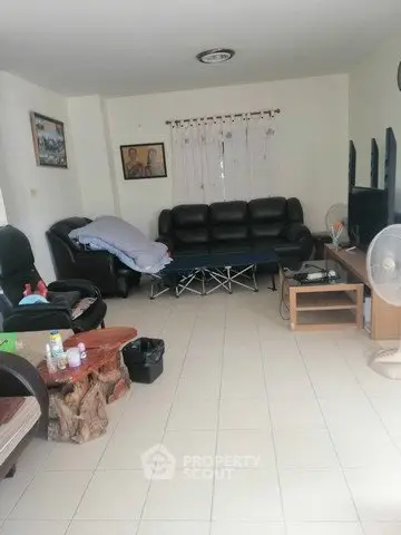 Spacious living room with leather sofas and modern entertainment center