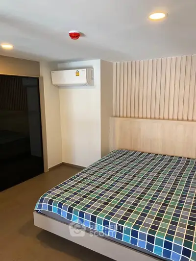 Modern bedroom with stylish wood paneling and air conditioning unit