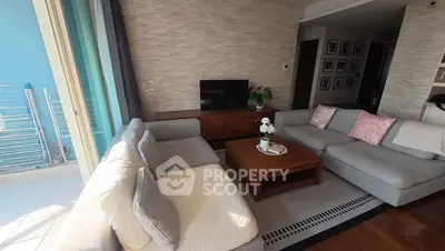 Spacious living room with modern decor and large windows for natural light.