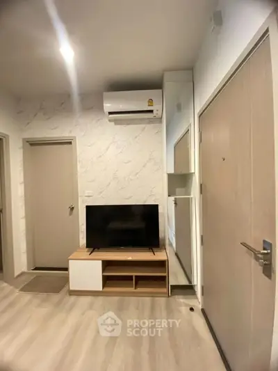 Modern living room with air conditioning and sleek TV setup