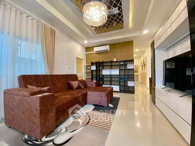 Luxurious living room with modern chandelier and stylish brown sofa