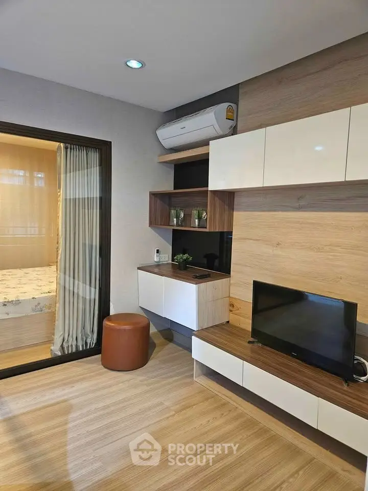 Modern living room with stylish wooden decor and air conditioning, featuring a cozy ambiance and sleek design.
