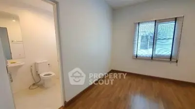 Spacious bedroom with ensuite bathroom and wooden flooring