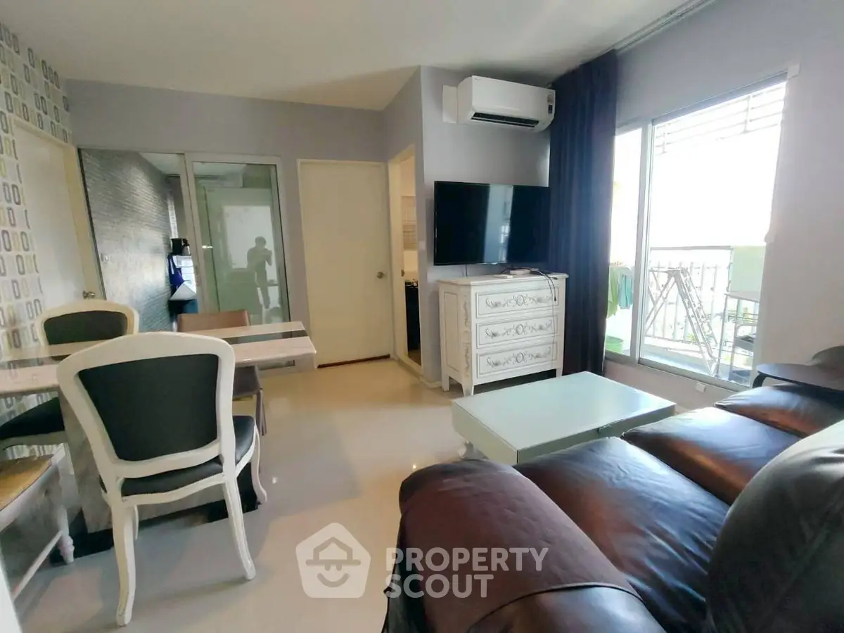 Stylish living room with modern furniture and balcony view in a chic apartment.