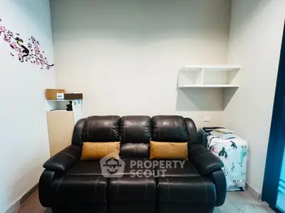 Cozy living room with leather sofa and minimalist decor, perfect for relaxation.