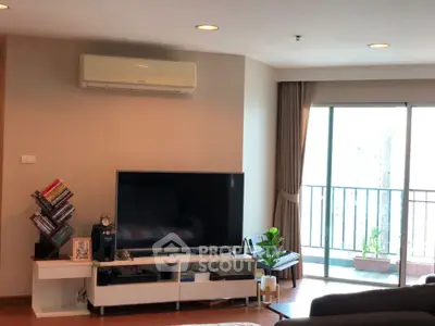 Spacious living room with modern decor and balcony view