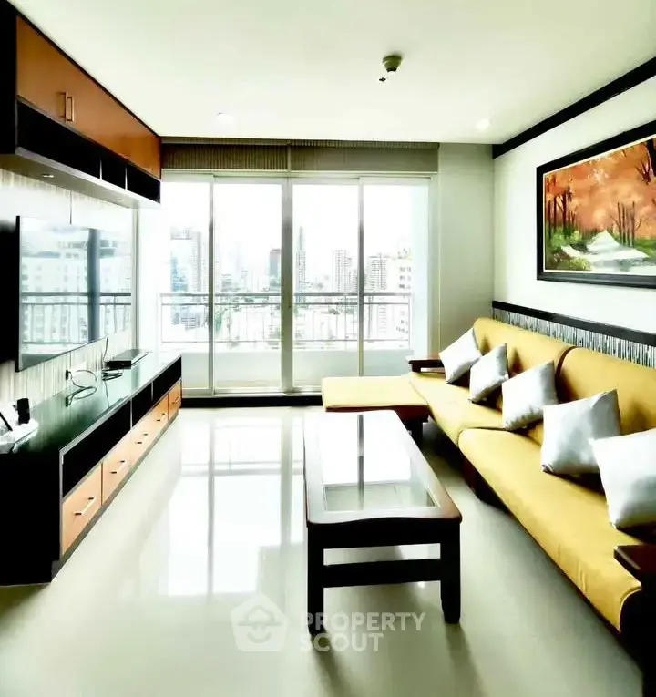 Spacious living room with modern decor and city view from large windows.