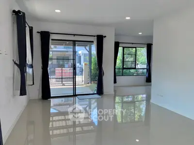 Spacious modern living room with glossy floors and large windows
