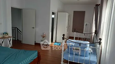 Spacious bedroom with elegant iron bed frames and ample natural light