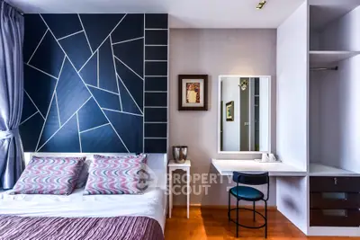 Modern bedroom with stylish geometric accent wall and cozy decor