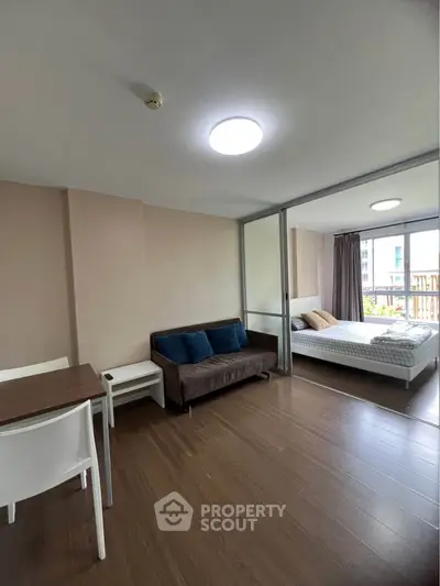Modern studio apartment with open layout and wooden flooring
