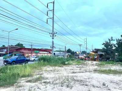 Vacant land plot with potential for development near commercial area and road access.