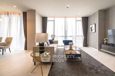 Luxurious modern living room with elegant decor and large windows for natural light.