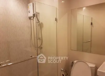 Modern bathroom with glass shower enclosure and sleek fixtures