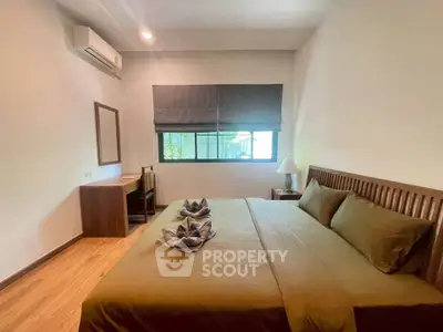 Cozy bedroom with modern furnishings and natural light, perfect for relaxation and comfort.