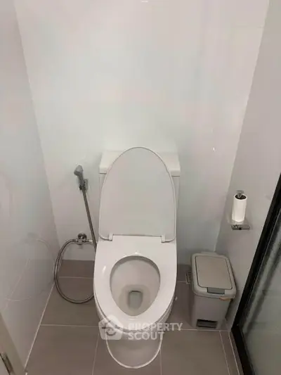 Modern bathroom with sleek toilet and minimalistic design, perfect for contemporary living spaces.