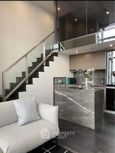 Modern duplex apartment with sleek kitchen and stylish staircase