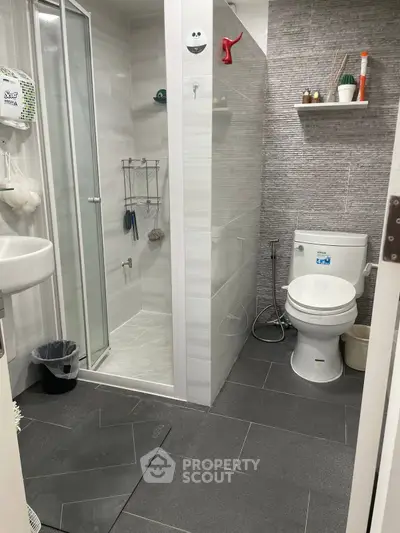 Modern bathroom with sleek shower and stylish gray tiles