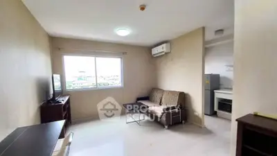Cozy living room with modern furniture and large window offering natural light.