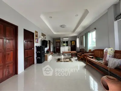 Spacious living room with elegant wooden furniture and large windows for natural light.