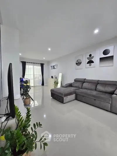 Spacious modern living room with sleek gray sofa and stylish decor