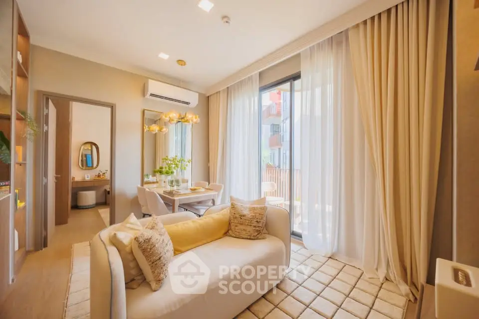Bright and modern living room with elegant decor and large windows leading to a balcony.