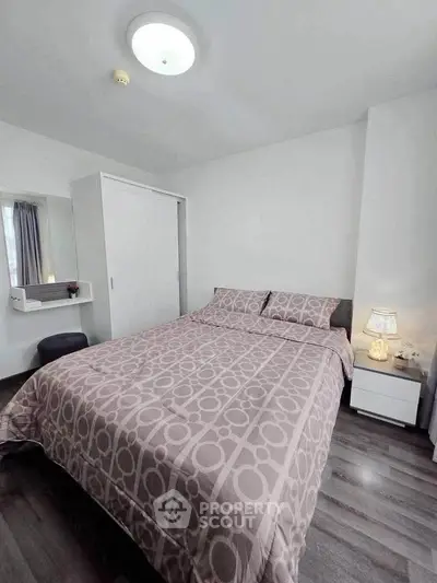 Cozy bedroom with modern decor and ample natural light