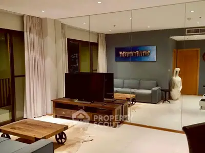 Stylish living room with modern decor and mirrored wall, perfect for urban living.