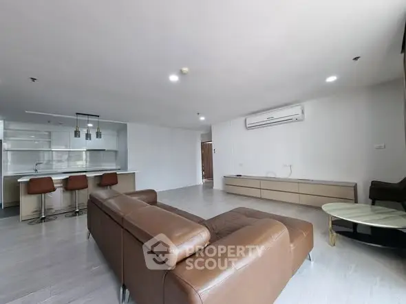 Spacious modern living room with open kitchen and stylish furniture