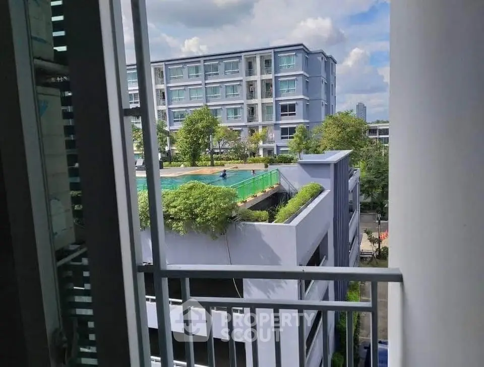 Modern apartment view with lush greenery and urban skyline