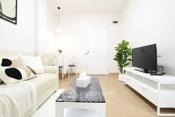 Modern living room with minimalist decor and cozy seating area.