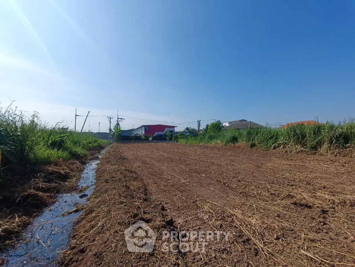 Expansive plot of land with clear blue sky, ideal for development opportunities.