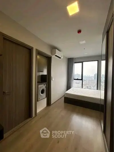 Modern bedroom with city view, featuring built-in wardrobe and air conditioning.