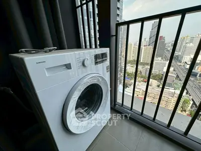 Modern washing machine on high-rise balcony with stunning city view