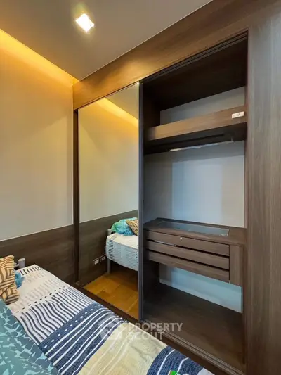 Modern bedroom with built-in wooden wardrobe and cozy bedding